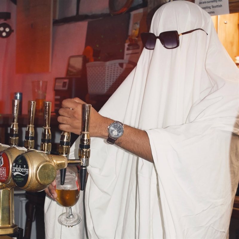 The ghost pulling a pint behind the bar